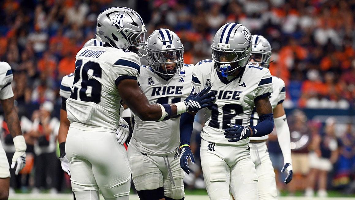 rice football players celebrate