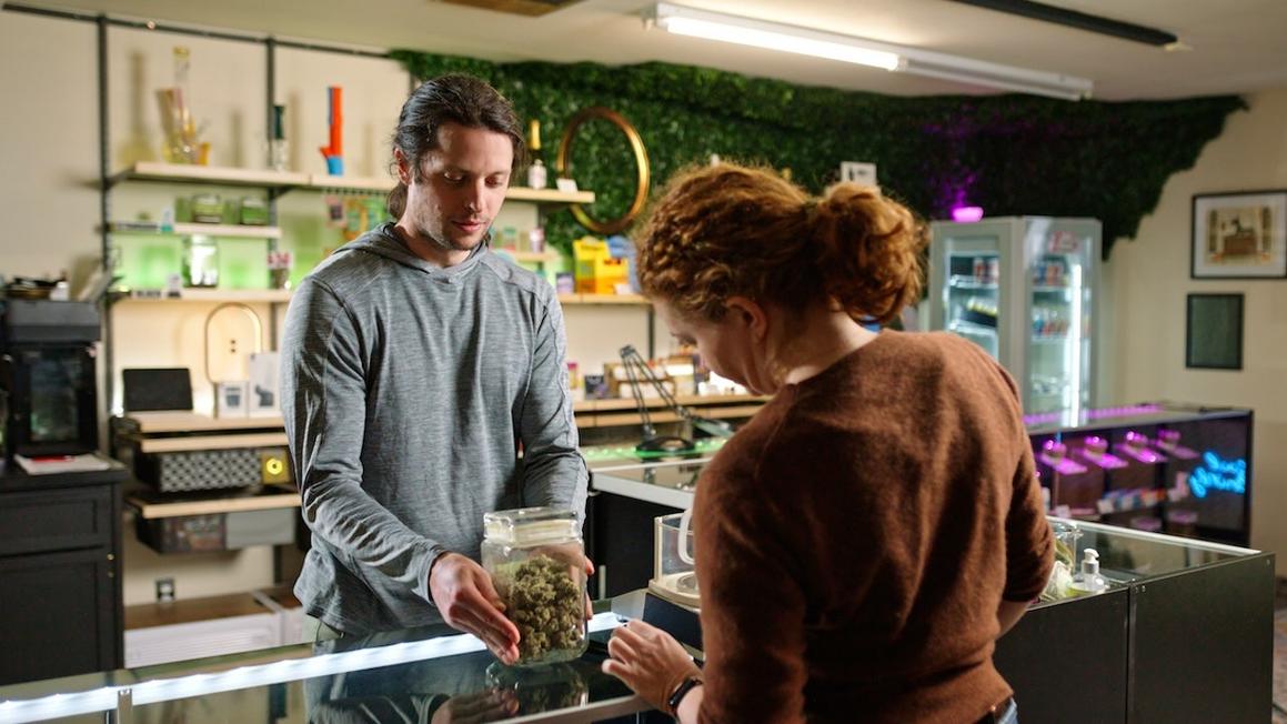 woman buying cannabis at dispensary