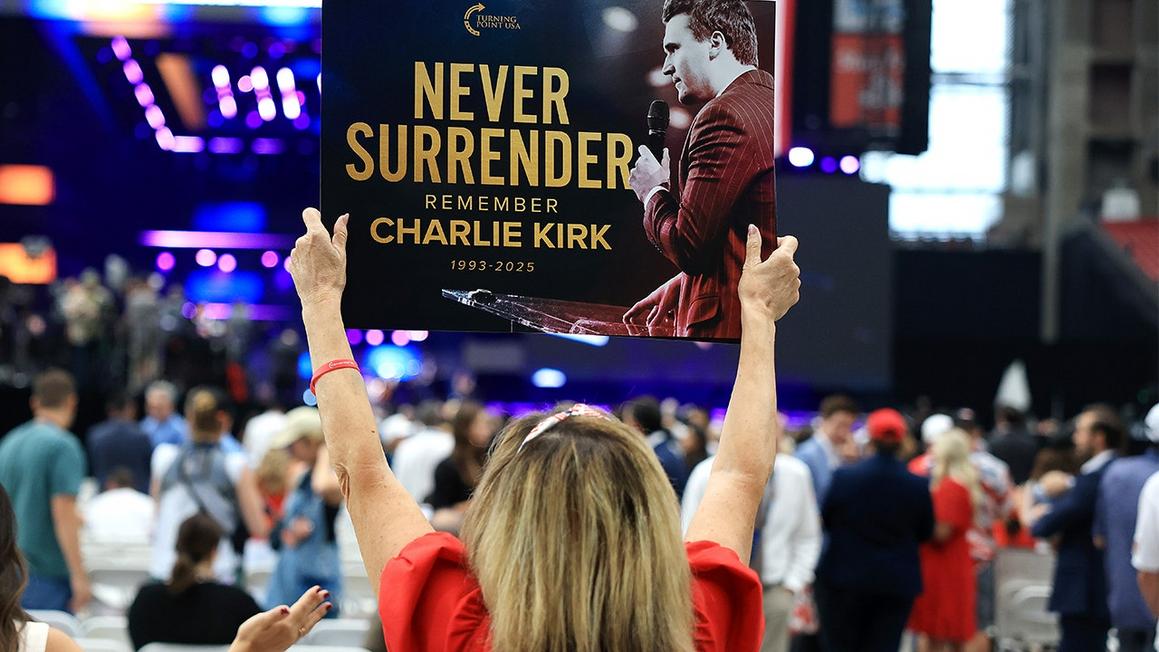 woman charlie kirk sign