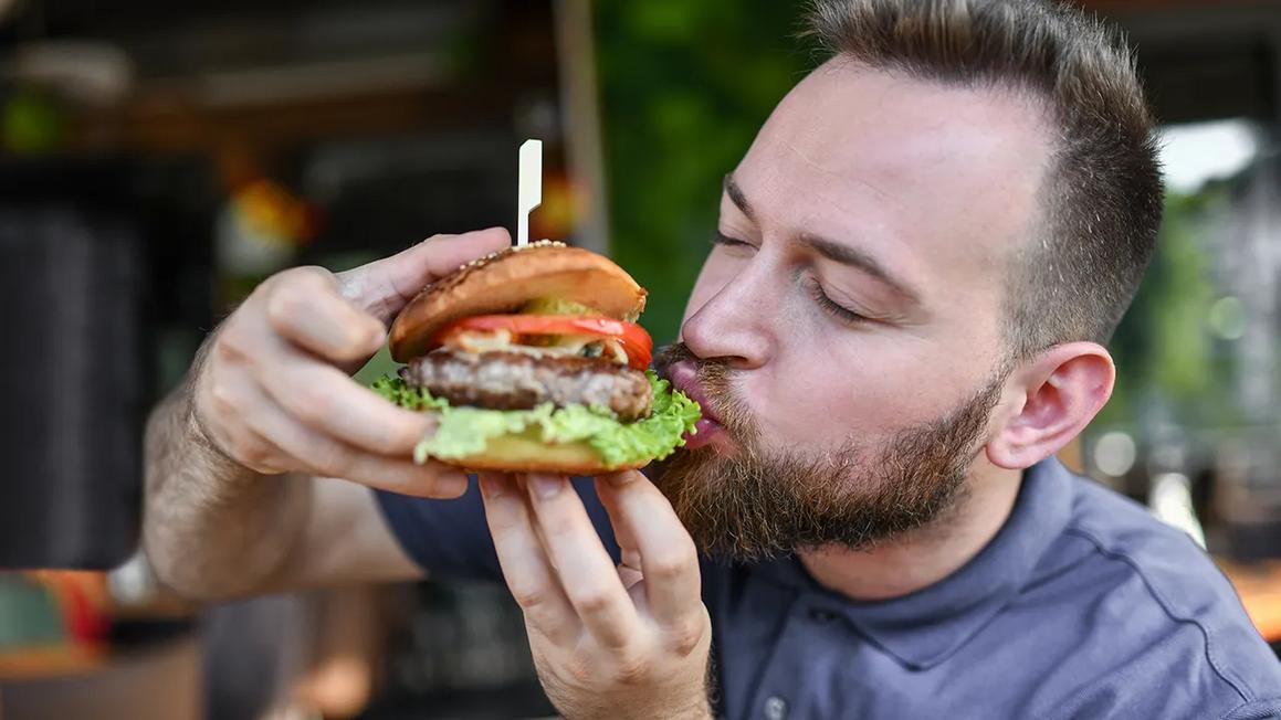 man eating burger lettuce 1