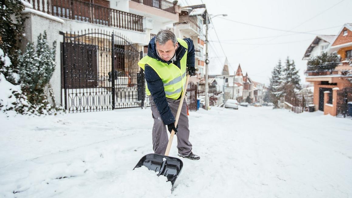 older man shoveling snow