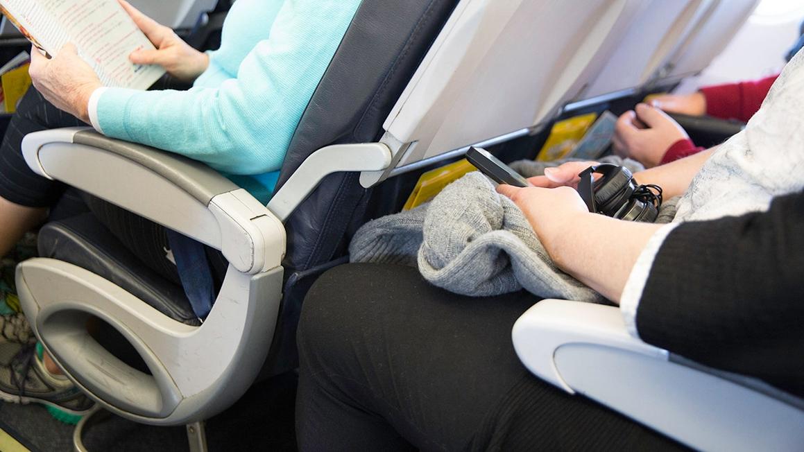 passengers cramped in airplane seats