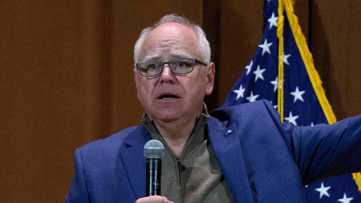 tim walz holding microphone