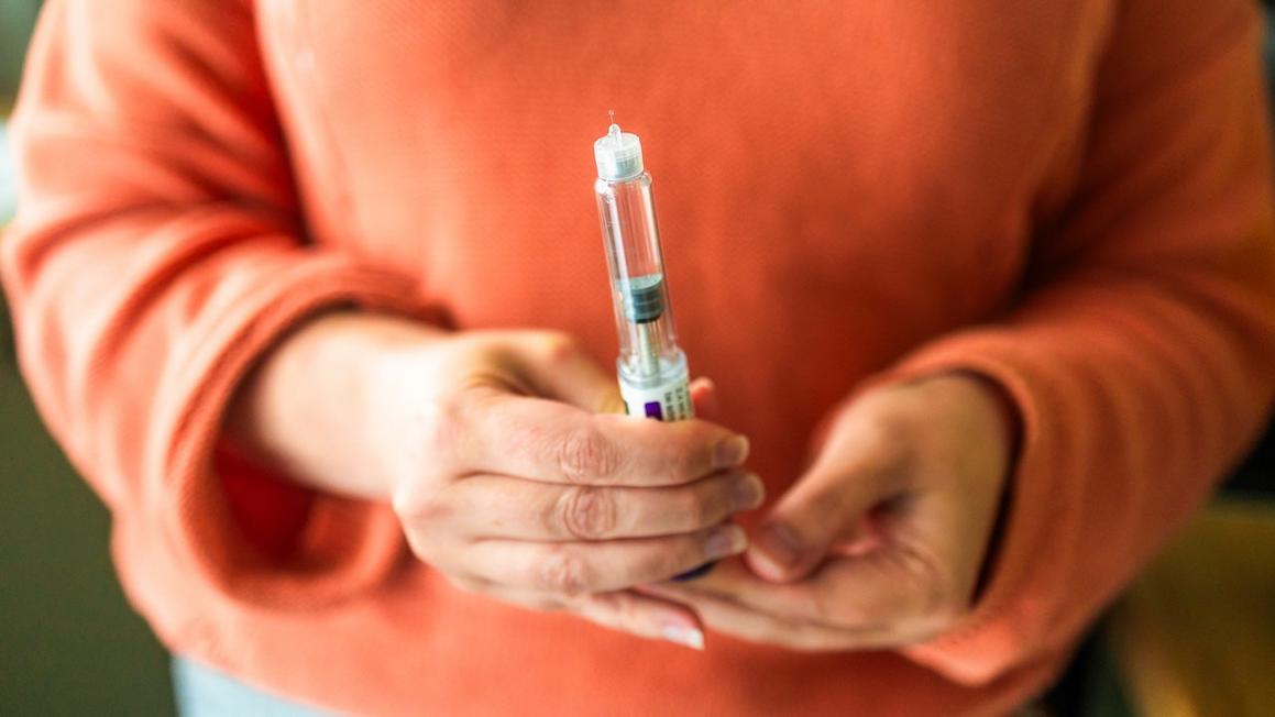 woman holding glp1 medications