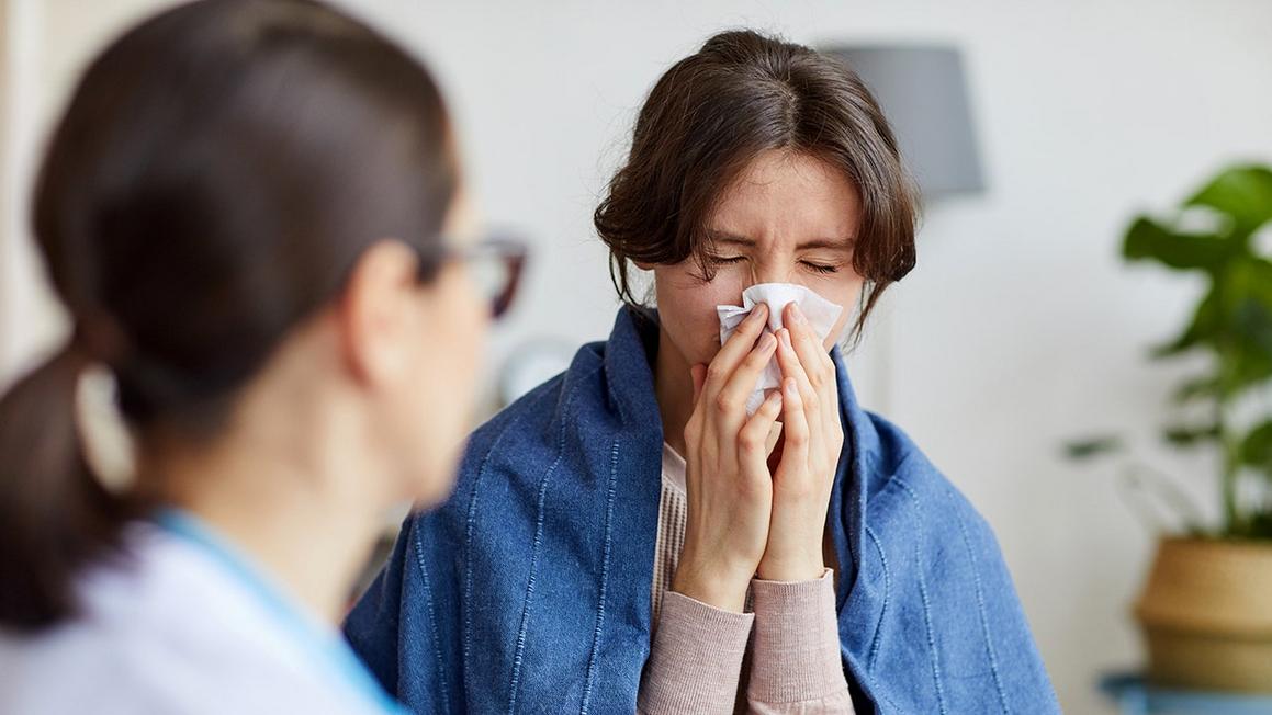 woman sick flu at doctor