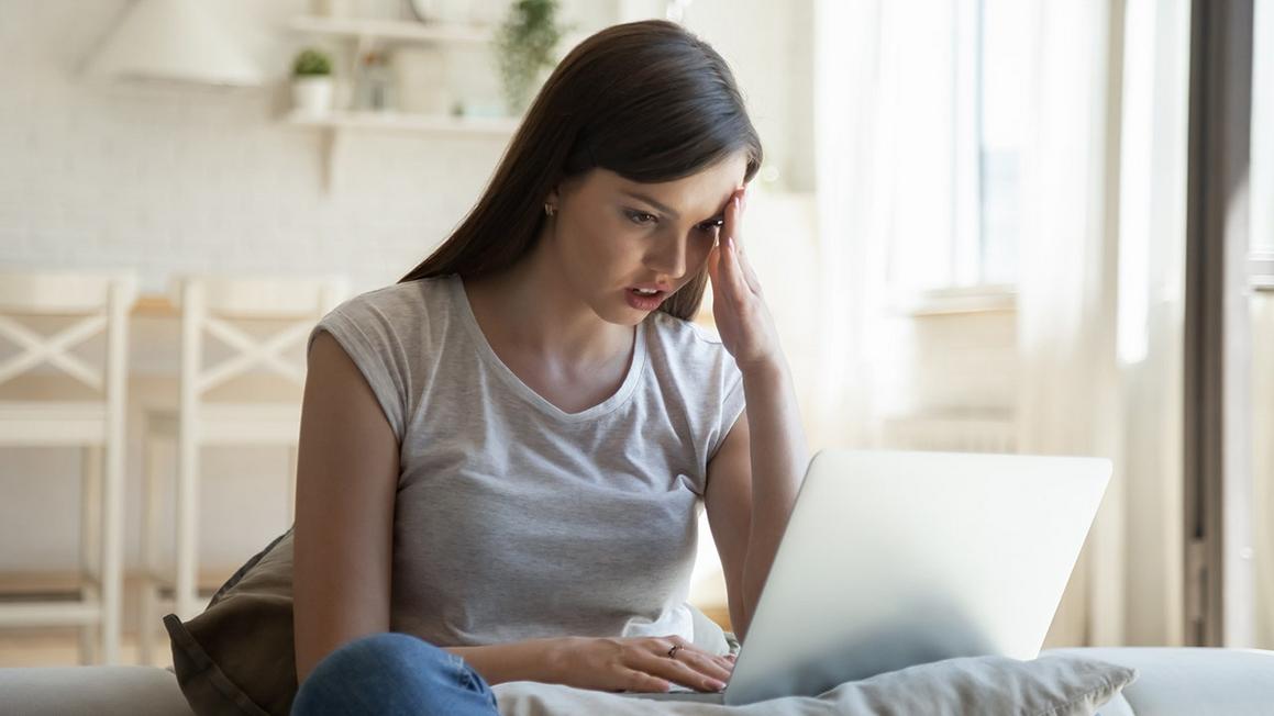 woman stressed looking at laptop