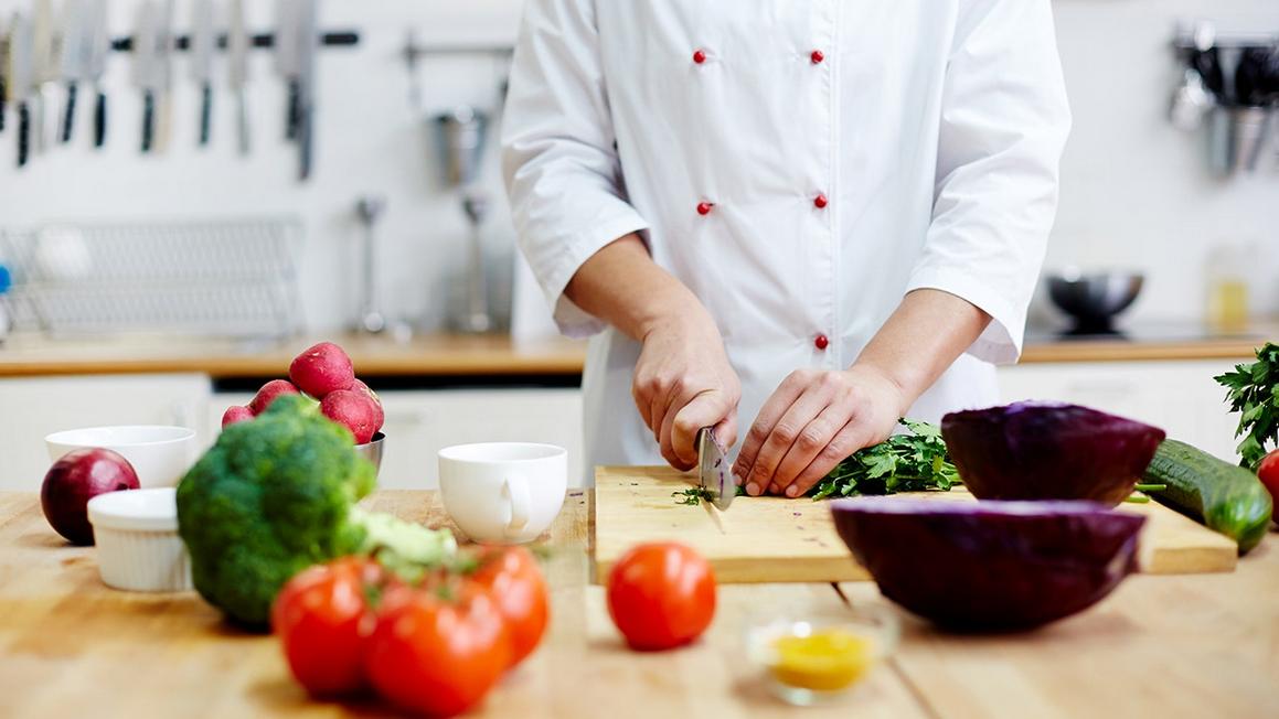 chef cutting vegetables in kitchen 1