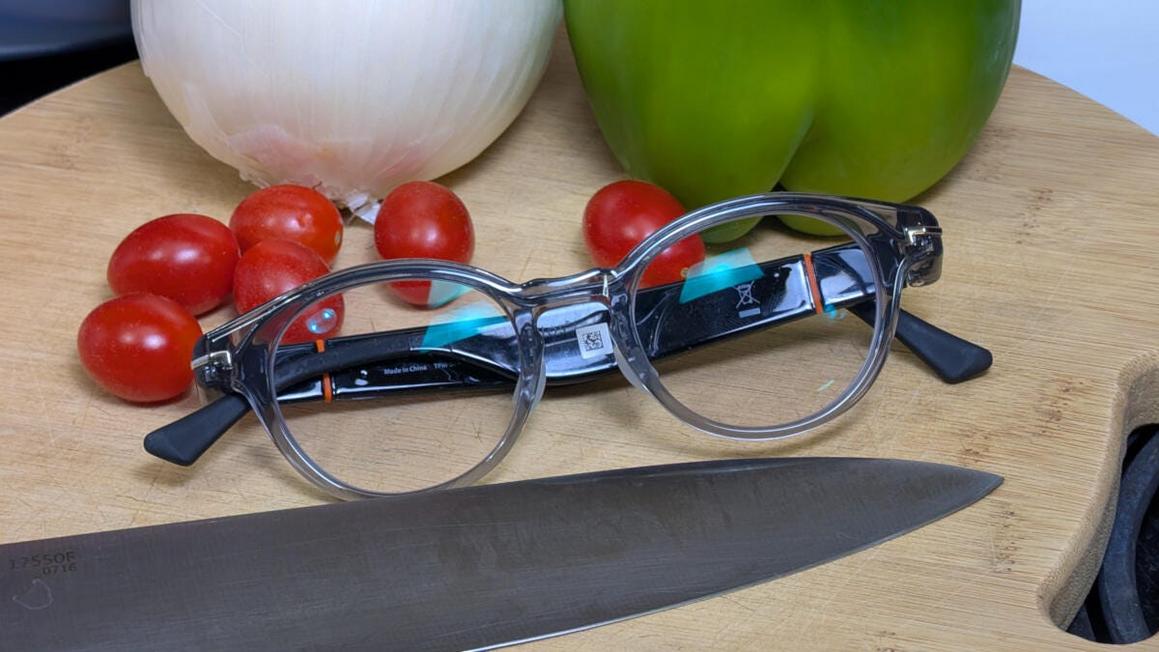 closeup of solos airgo a5 smart glasses resting on cutting board with knife and vegetables