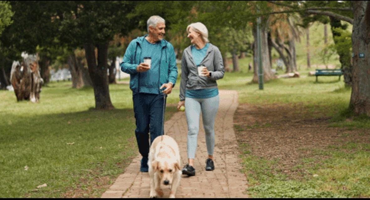 couple exercising walking dog