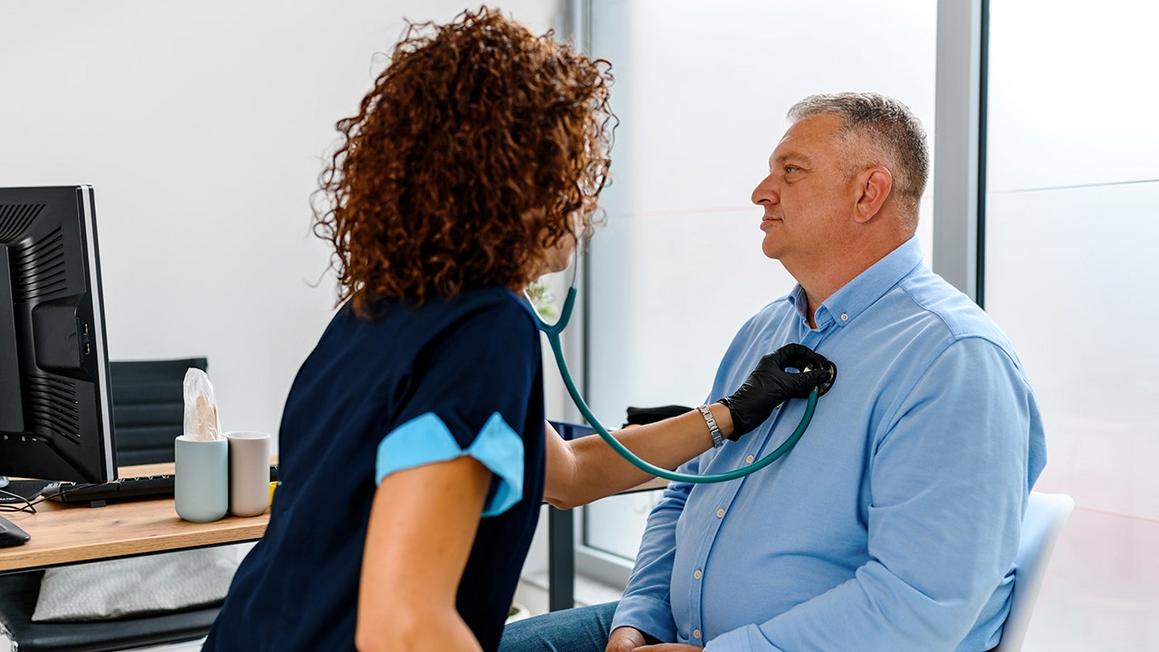 doctor checking mans heart health