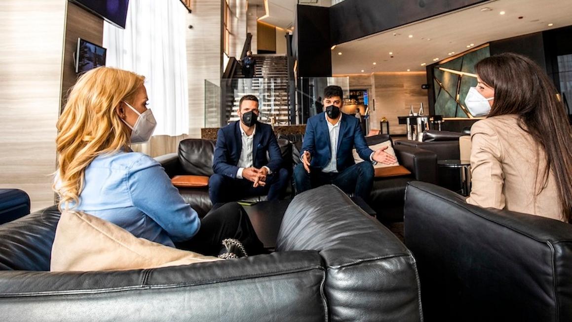 masked people talking hotel lobby flu spread