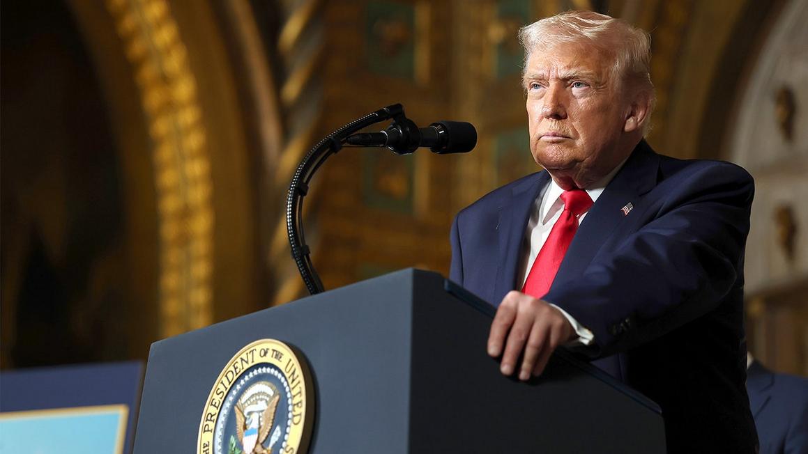 president trump stands at podium