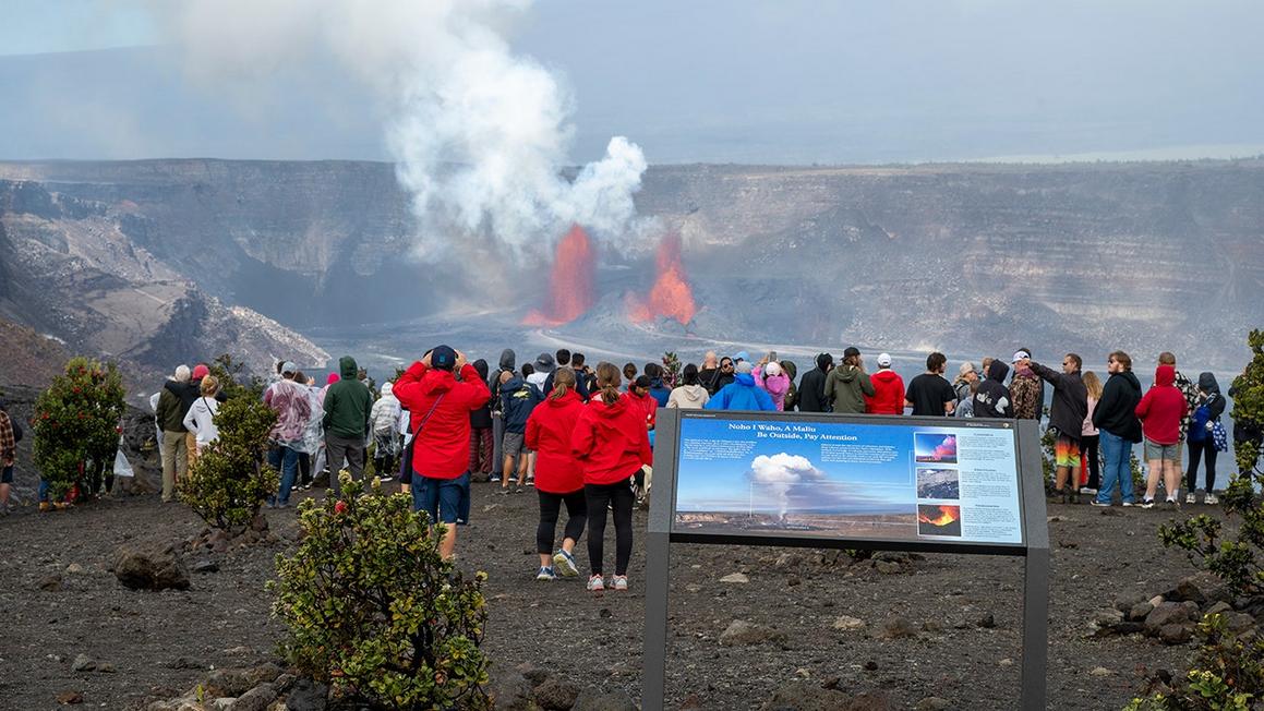 visitors watch eruption of kilauea volcano