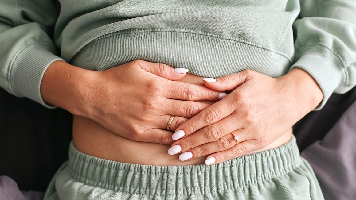 woman holding stomach gut health