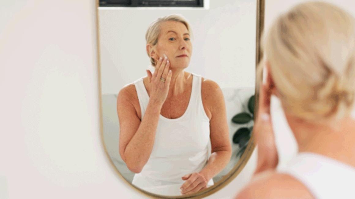 woman skin care at mirror